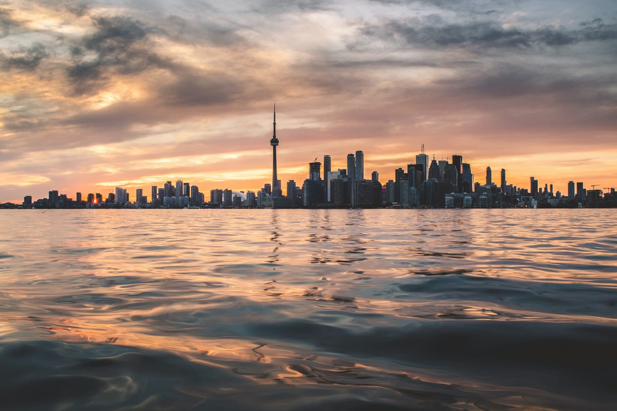The Toronto skyline across Lake Ontario at sunset