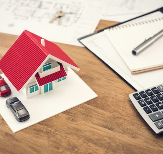 House model, calculator and documents on the table - real estate  financial concept